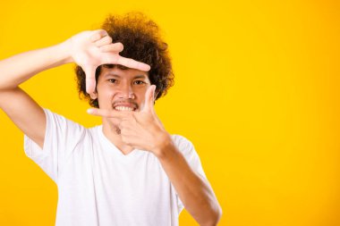 Asian handsome man with curly hair he smiling making frame with 
