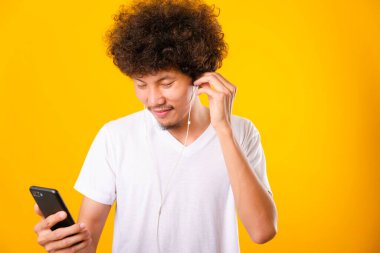 Happy asian handsome man with curly hair he smiling enjoying lis