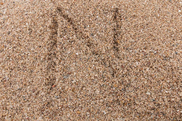 Character N of the alphabet writing on the sand