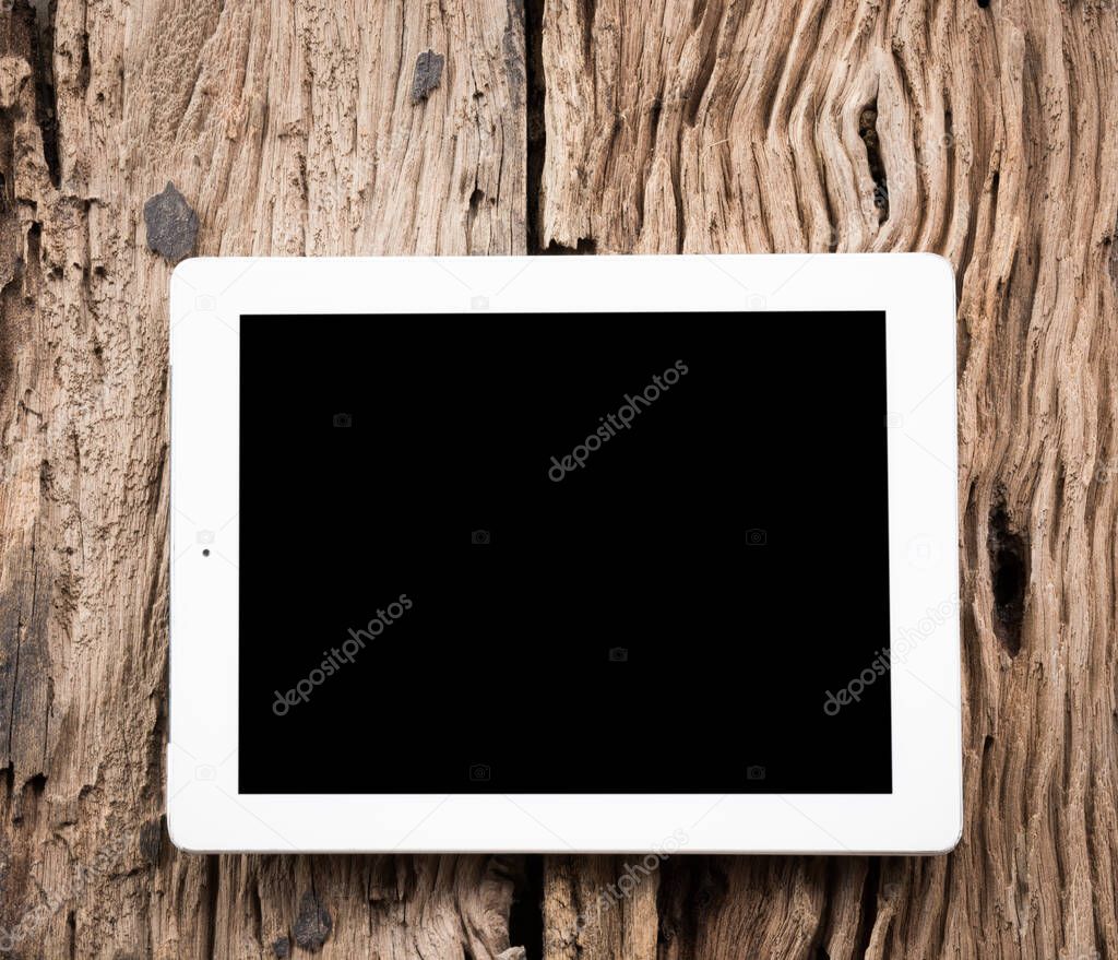 White Tablet pc on old wooden table
