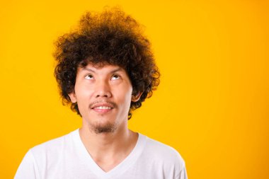 Asian handsome man with curly hair looking up see he hair isolat