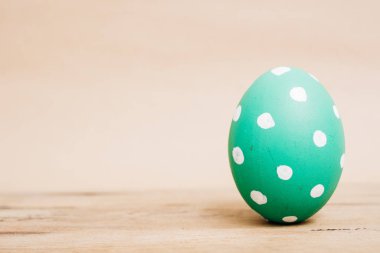 Beautiful Easter Green egg on wooden background,