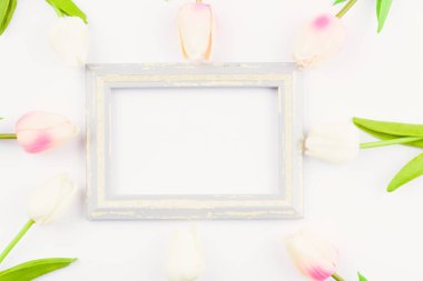 Happy Women's Day, Mother's Day and Valentine's Day concept. top view flat lay Tulip flower and photo frame on white background, copy space for your text