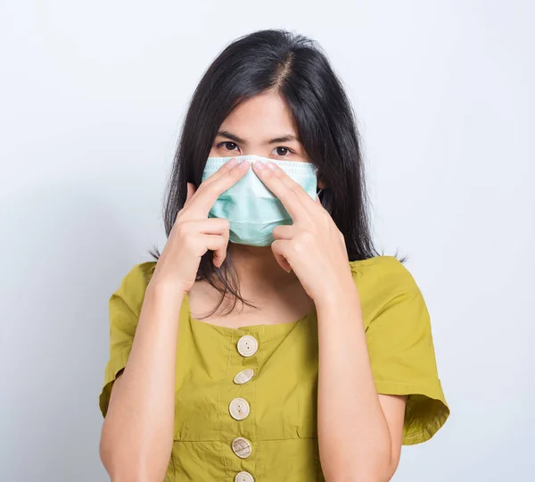 Portrait Asian beautiful happy young woman wearing face mask protects filter dust pm2.5 anti-pollution, anti-smog and air pollution on a white background, with copy space