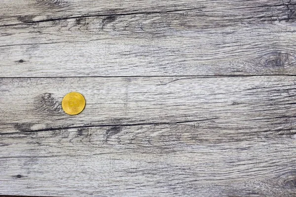 Bitcoin on natural old wooden board texture. — Stock Photo, Image