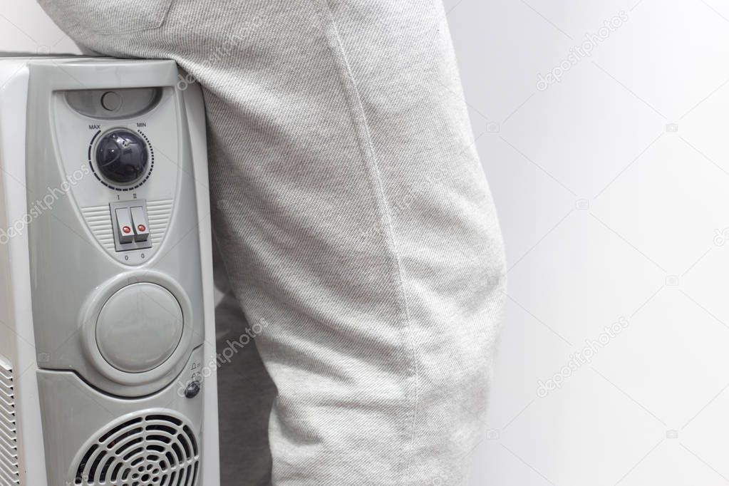 unknown man sitting on gray oil heater.