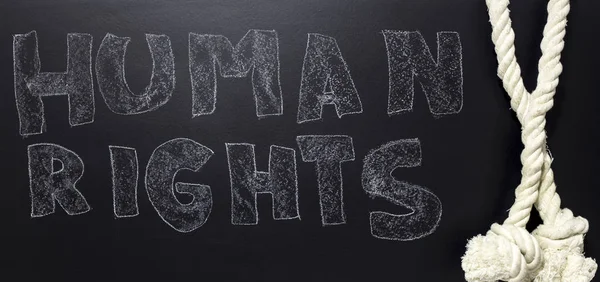 Written human rights with rope on the blackboard. — Stock Photo, Image