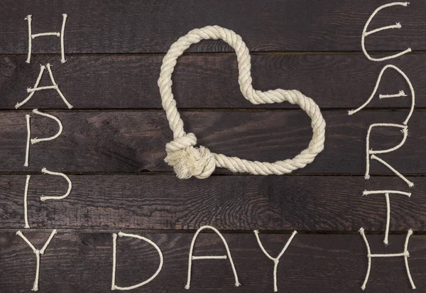Earth Day concept. Rope in shape of love heart with text: Happy Earth Day