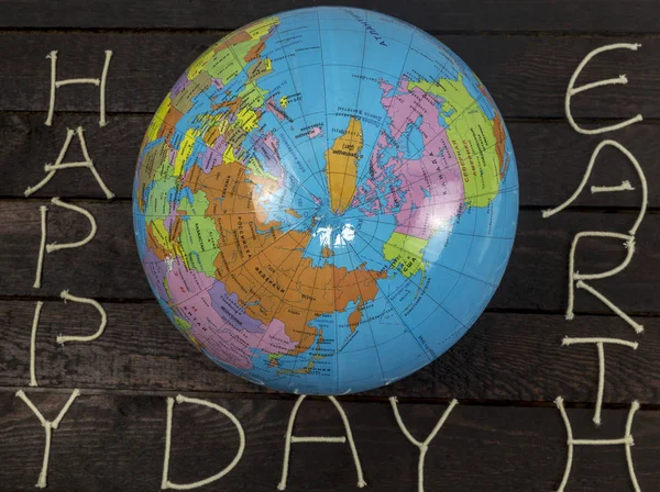 De dag van de concept-aarde. Globe legt op houten achtergrond — Stockfoto
