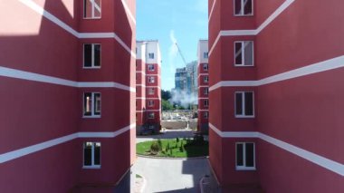 Construction site with a bird's eye in a megacity. New house in a new residential complex. Flying over the construction site. aerial panoramic top view from hight copter drone flying sky footage