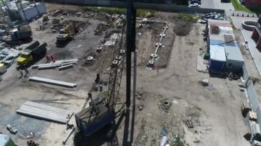 Construction site with a bird's eye in a megacity. New house in a new residential complex. Flying over the construction site. aerial panoramic top view from hight copter drone flying sky footage