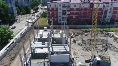 Construction site with a bird's eye in a megacity. New house in a new residential complex. Flying over the construction site. aerial panoramic top view from hight copter drone flying sky footage
