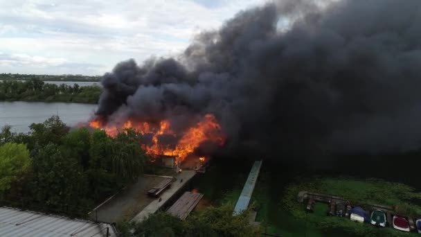 大火后燃烧的工业仓库中心建筑的空中景观 燃烧的屋顶冒着巨大的烟 无人驾驶飞机发射野火烧毁建筑大火 — 图库视频影像