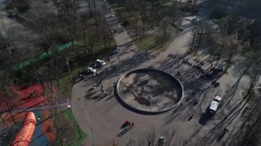 Dnipro, Ukrayna - Devriye arabası şehir parkındaki ağaçların arkasına park edilmiş. Ilık bahar günü. Çevredeki ağaçlarda taze yeşiller