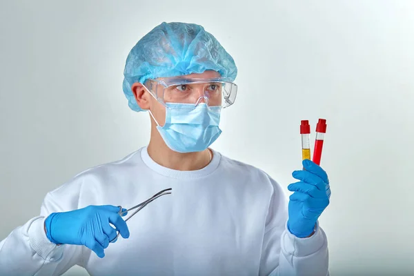 Doctor in mask performing blood test for coronavirus COVID19, HIV, ebola or other dangerous infection. Medical background, instruments, template, wallpaper. Coronavirus disease concept