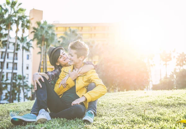 Happy Gay Couple Hugging Laughing Together Sitting Grass Park Young — Stock Photo, Image