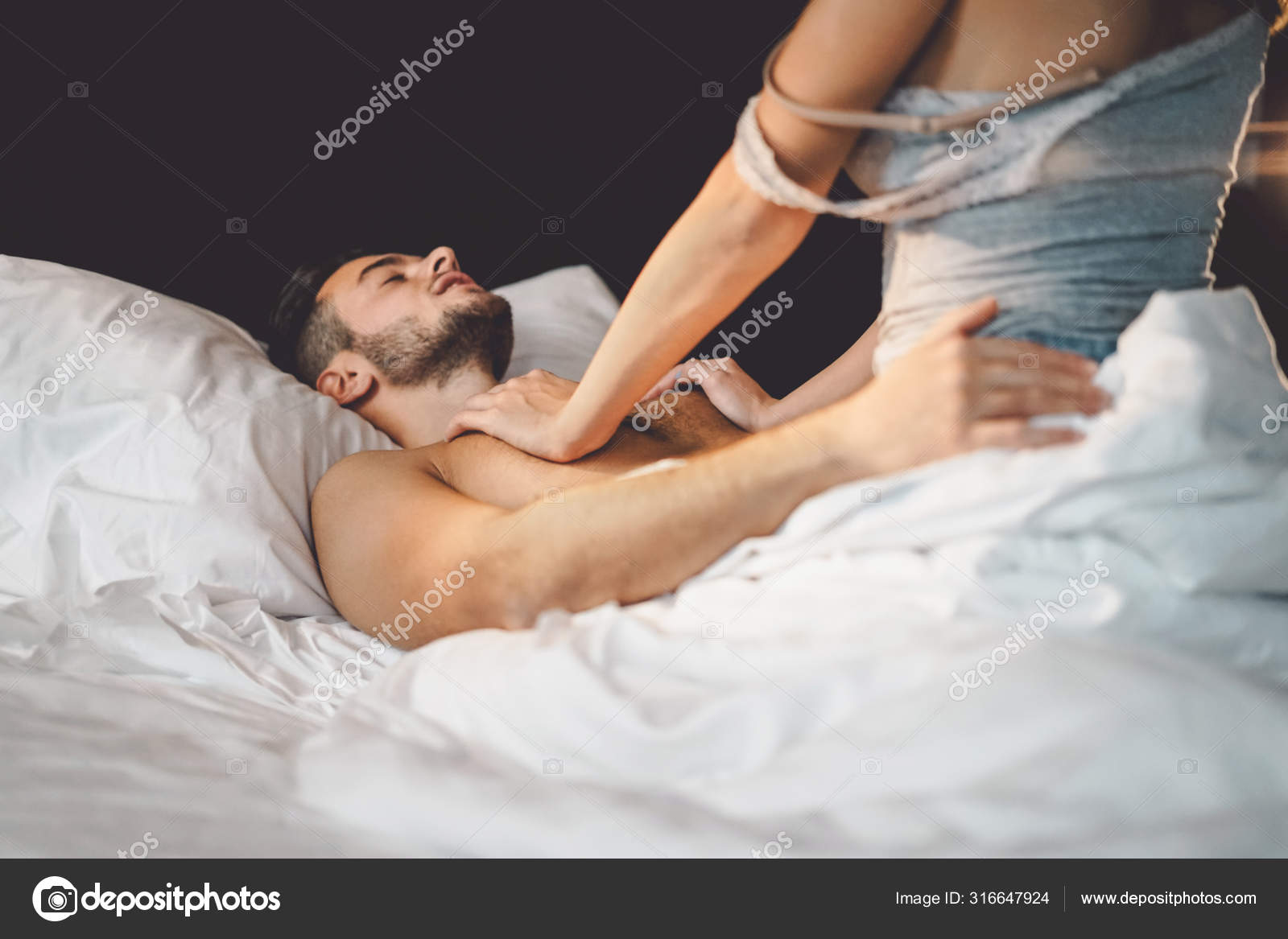 Young horny couple having romantic sex on the bed