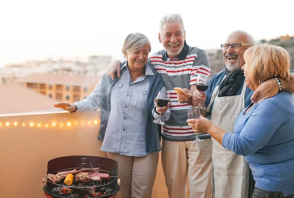 Happy Senior Friends Having Fun Cheering Red Wine Barbecue Terrace — 스톡 사진