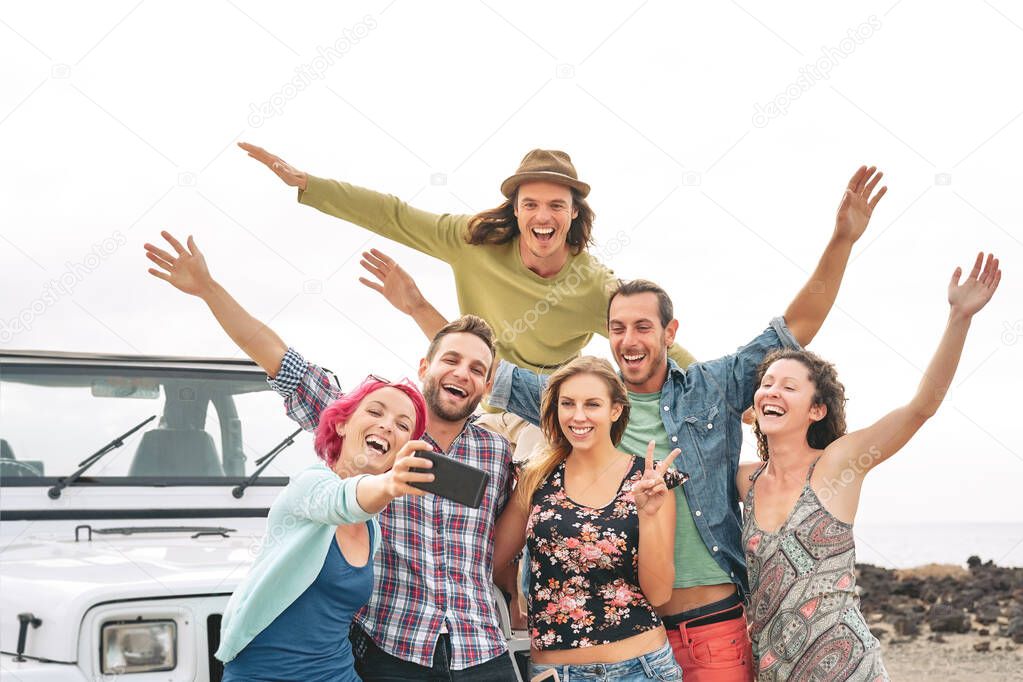 Group young friends taking selfie with mobile smartphones during road trip - Happy travel people having fun in vacation - Friendship lifestyle and youth culture concept