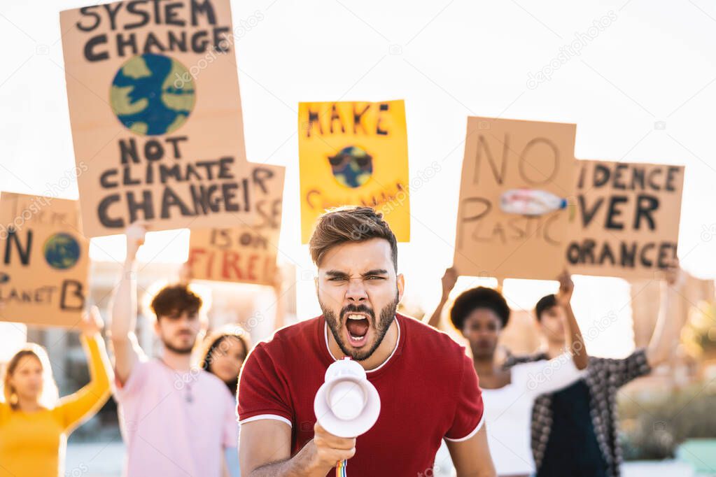 Group demonstrators protesting against plastic pollution and climate change - Multiracial people fighting on road holding banners on environments disasters - Global warming concept