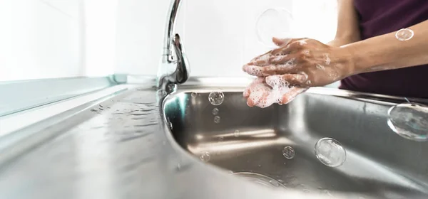 Female washing hands with liquid soap for preventing and stop corona virus spreading - Hygiene and healthcare people concept