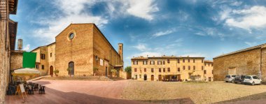 Panoramic view with the Church of Sant'Agostino, landmark in the medieval town of San Gimignano, Tuscany, Italy clipart