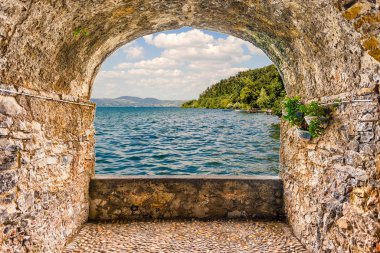 İtalya 'nın Anguillara kentinden Bracciano Gölü manzaralı kaya kemer balkonu.