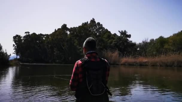 Hisaronu Orhaniye, Marmaris - Mugla / Turkey. March 12, 2020. Trout hunt between reedy. in Hisaronu.Bass hunt between reedy in Hisaronu. Fishing in a sunny day. — Stock Footage Hisaronu Orhaniye Marmaris Mugla Turkey March 2020 Trout Hunt Reedy Stock Footage
