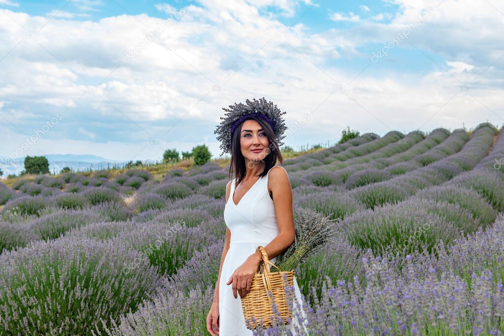 Turkey's lavender paradise: Kuyucak Village, Isparta - Turkey . Beautiful woman in the lavander field of the Kuyucak Isparta. Woman model is walking through lavender fields. 