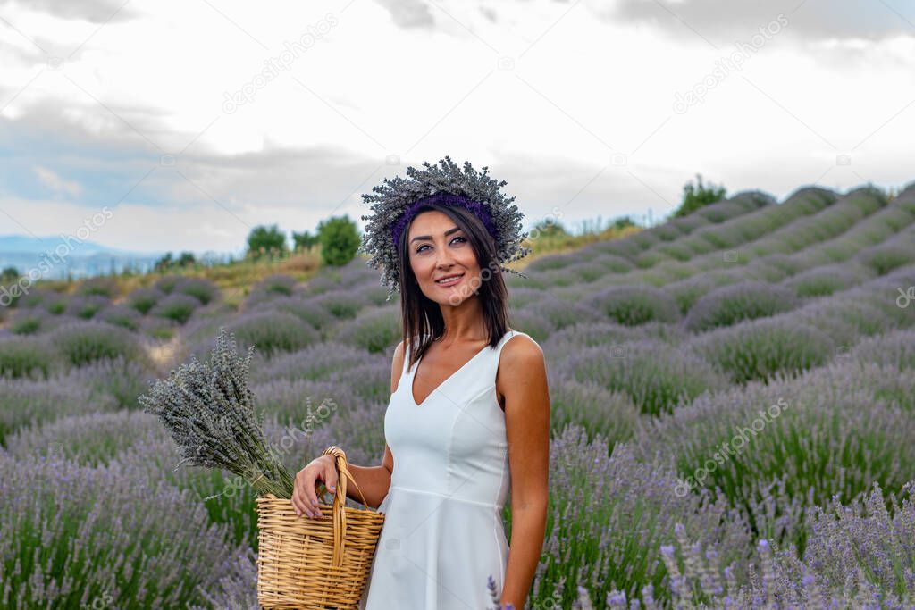 Turkey's lavender paradise: Kuyucak Village, Isparta - Turkey . Beautiful woman in the lavander field of the Kuyucak Isparta. Woman model is walking through lavender fields. 