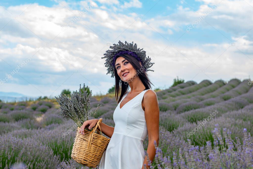 Turkey's lavender paradise: Kuyucak Village, Isparta - Turkey . Beautiful woman in the lavander field of the Kuyucak Isparta. Woman model is walking through lavender fields. 