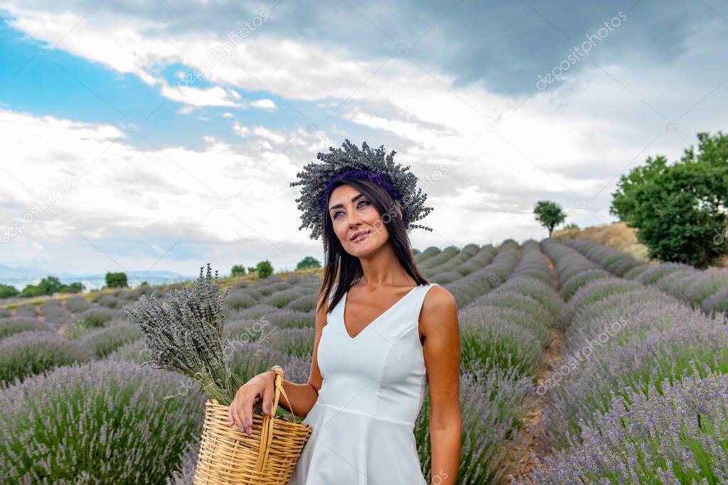 Turkey's lavender paradise: Kuyucak Village, Isparta - Turkey . Beautiful woman in the lavander field of the Kuyucak Isparta. Woman model is walking through lavender fields. 