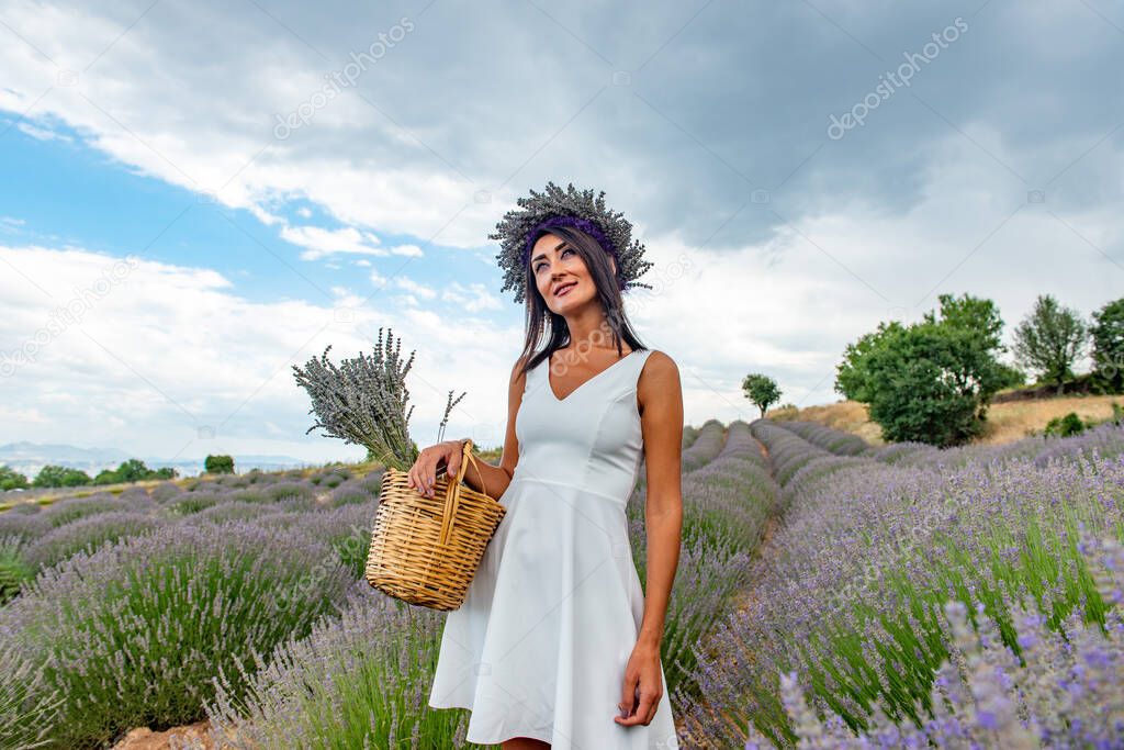 Turkey's lavender paradise: Kuyucak Village, Isparta - Turkey . Beautiful woman in the lavander field of the Kuyucak Isparta. Woman model is walking through lavender fields. 