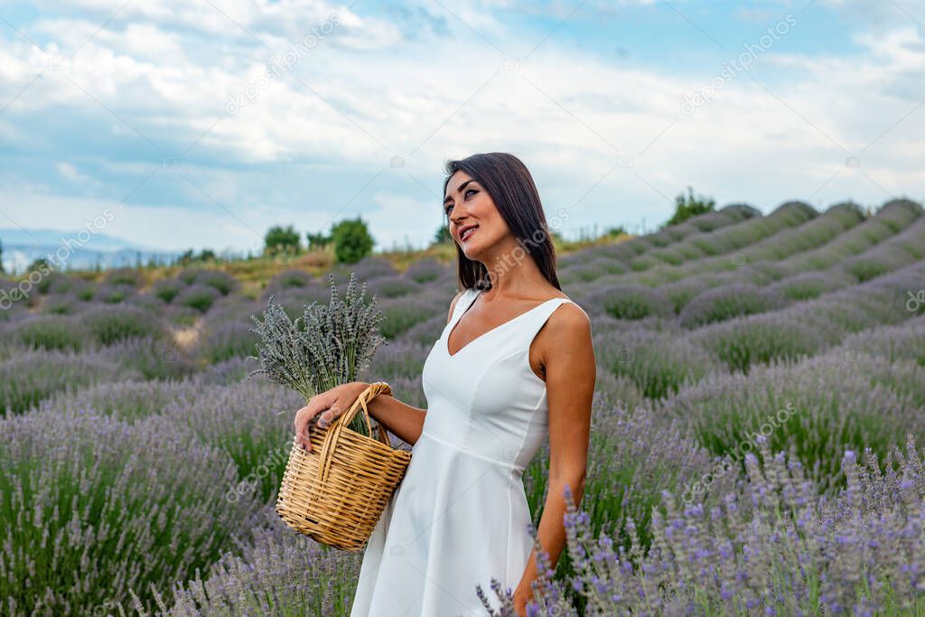 Turkey's lavender paradise: Kuyucak Village, Isparta - Turkey . Beautiful woman in the lavander field of the Kuyucak Isparta. Woman model is walking through lavender fields. 