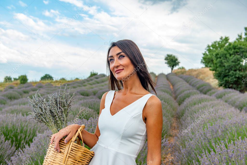 Turkey's lavender paradise: Kuyucak Village, Isparta - Turkey . Beautiful woman in the lavander field of the Kuyucak Isparta. Woman model is walking through lavender fields. 