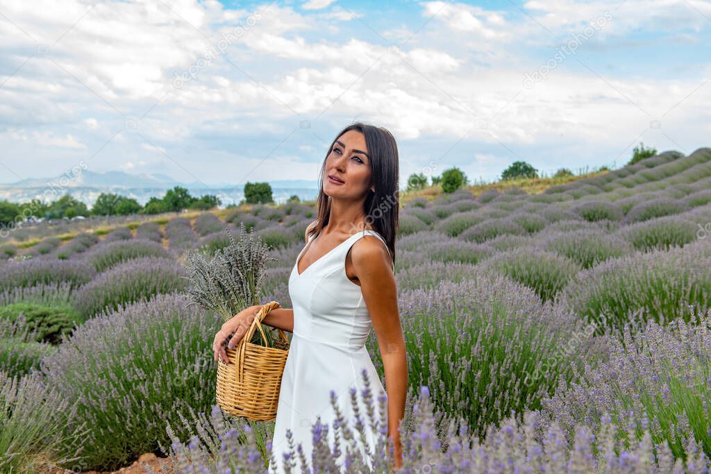 Turkey's lavender paradise: Kuyucak Village, Isparta - Turkey . Beautiful woman in the lavander field of the Kuyucak Isparta. Woman model is walking through lavender fields. 