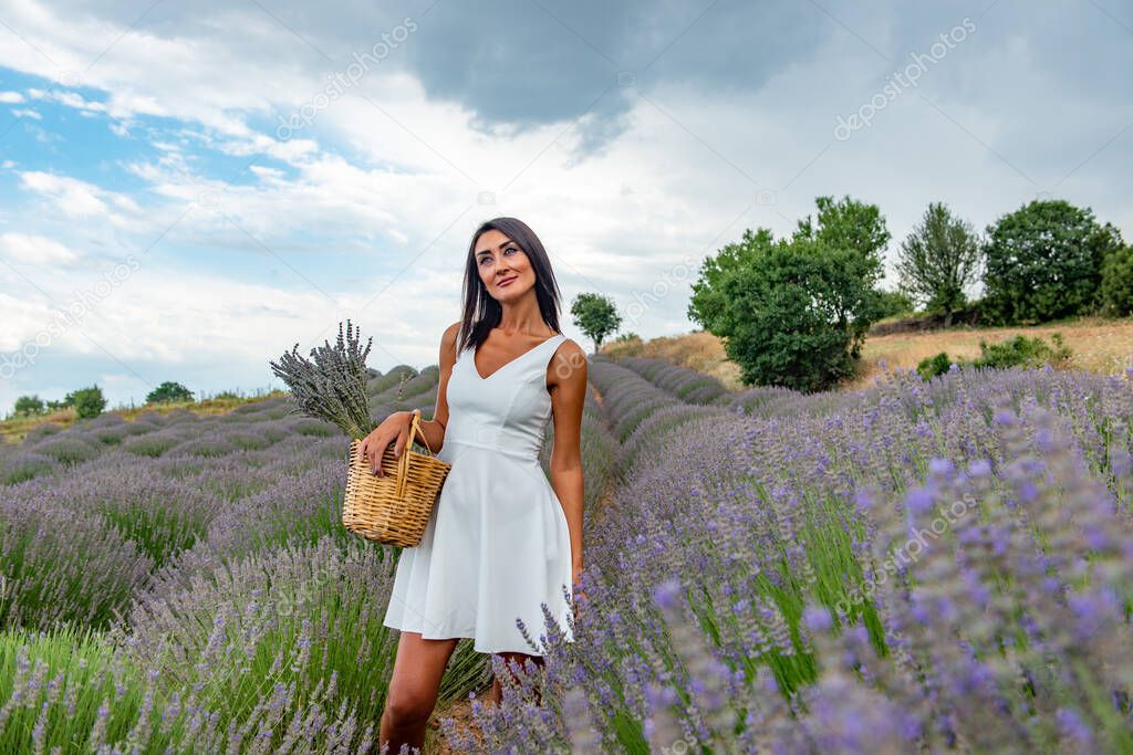 Turkey's lavender paradise: Kuyucak Village, Isparta - Turkey . Beautiful woman in the lavander field of the Kuyucak Isparta. Woman model is walking through lavender fields. 