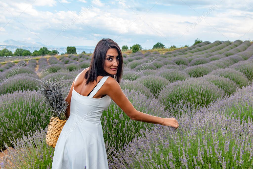 Turkey's lavender paradise: Kuyucak Village, Isparta - Turkey . Beautiful woman in the lavander field of the Kuyucak Isparta. Woman model is walking through lavender fields. 