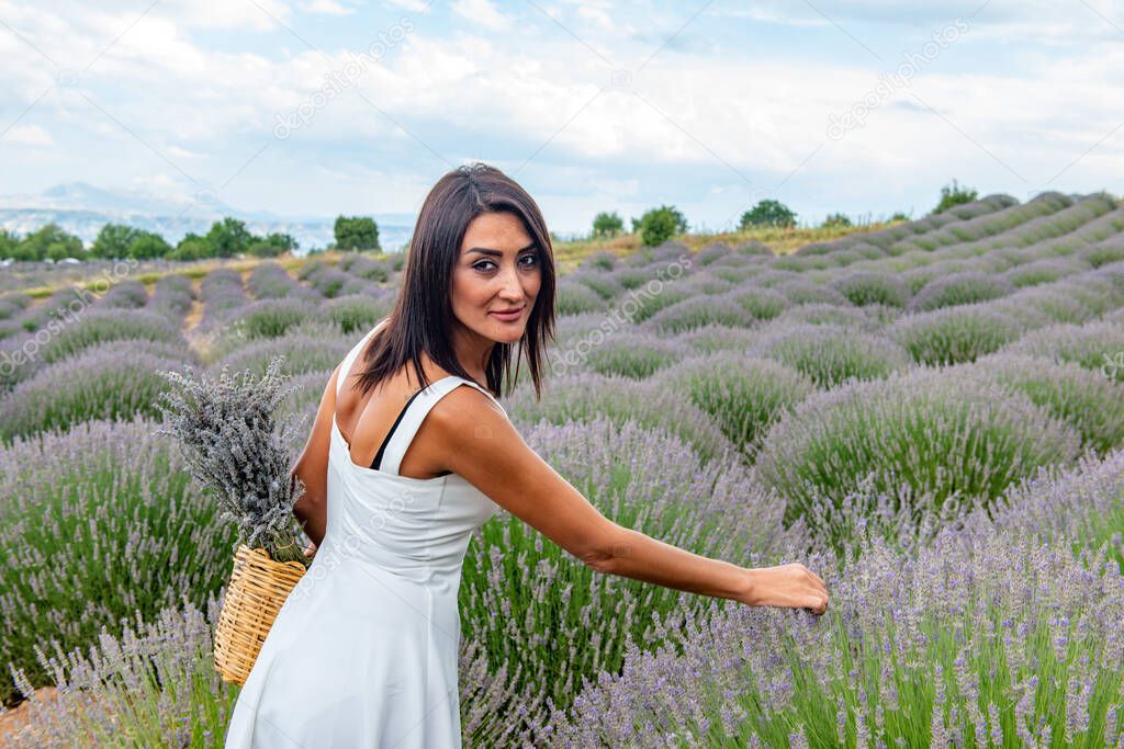 Turkey's lavender paradise: Kuyucak Village, Isparta - Turkey . Beautiful woman in the lavander field of the Kuyucak Isparta. Woman model is walking through lavender fields. 