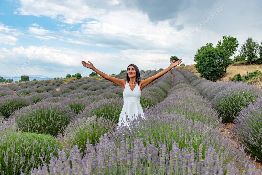 Turkey's lavender paradise: Kuyucak Village, Isparta - Turkey . Beautiful woman in the lavander field of the Kuyucak Isparta. Woman model is walking through lavender fields. 
