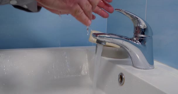 Parte del baño con un inodoro blanco y azulejos azules en las paredes y