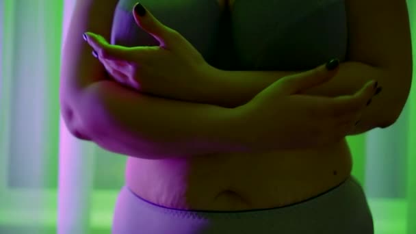 Close-up of a female fat body in gray underwear. the woman squeezes her huge Breasts, runs hand over stomach. the camera is moving. contoured green and lilac lights — Stock Footage Close-up of a female fat body in gray underwear. the woman squeezes her huge Breasts, runs hand over stomach. the camera is moving. contoured green and lilac lights Video Clip