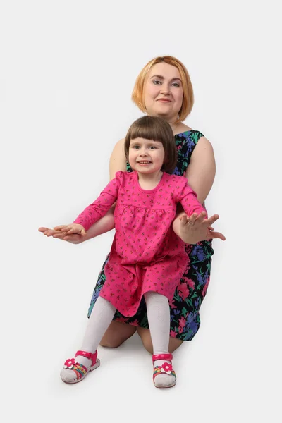 Mother with daughter on gray — Stock Photo, Image