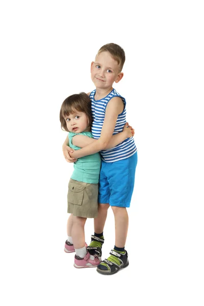 Little girl and elder boy stand embracing — Stock Photo, Image