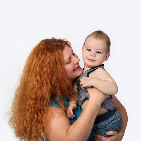 Happy redhead woman with little son on hands — Stock Photo, Image