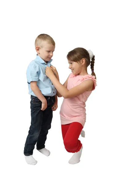 Girl buttoning shirt on boy — Stock Photo, Image