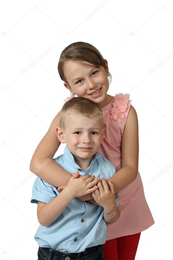 Boy and girl stand embraced