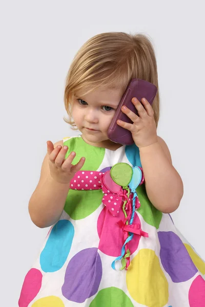 Little girl with cell phone on gray — Φωτογραφία Αρχείου