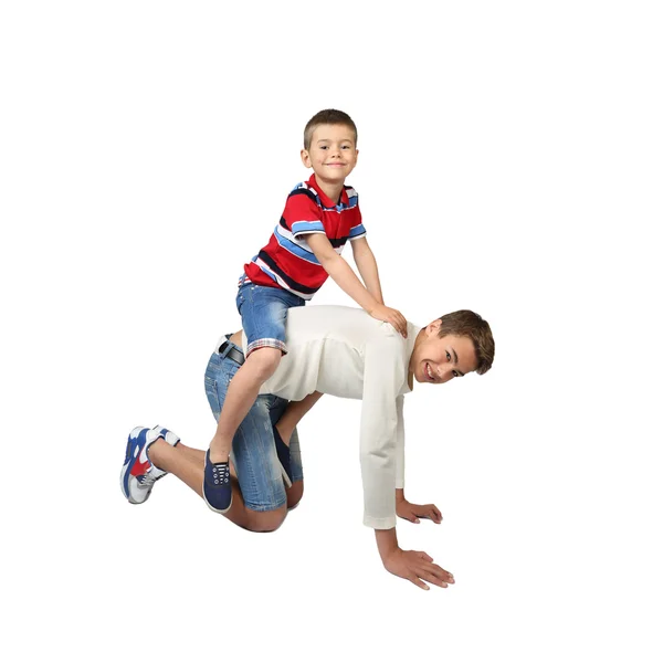 Older boy carries little brother on back — Stock Photo, Image