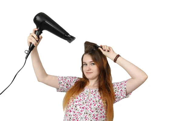 Young girl dries hair by hairdryer Stock Image